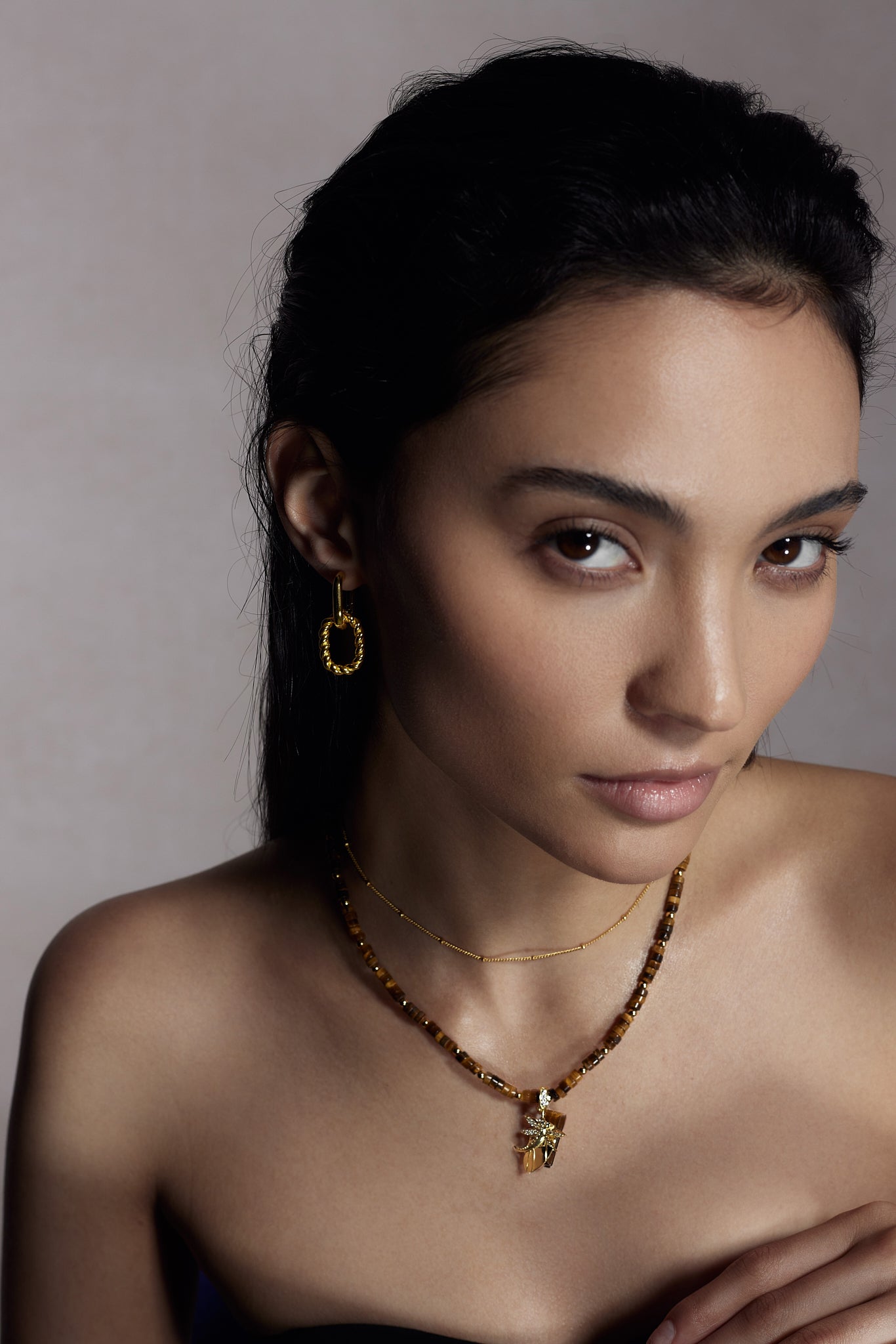 Rhea Gold Dot Necklace on model with layered necklaces - FREQNC