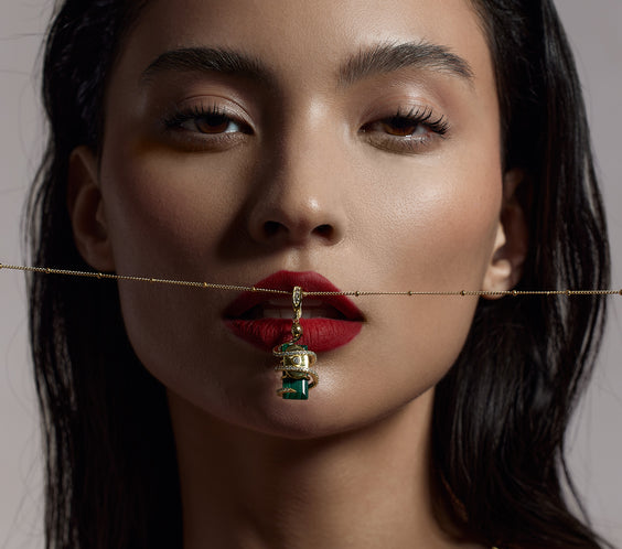 Serpent Charm pendant worn on model with gold chain necklace - FREQNC spirit animal