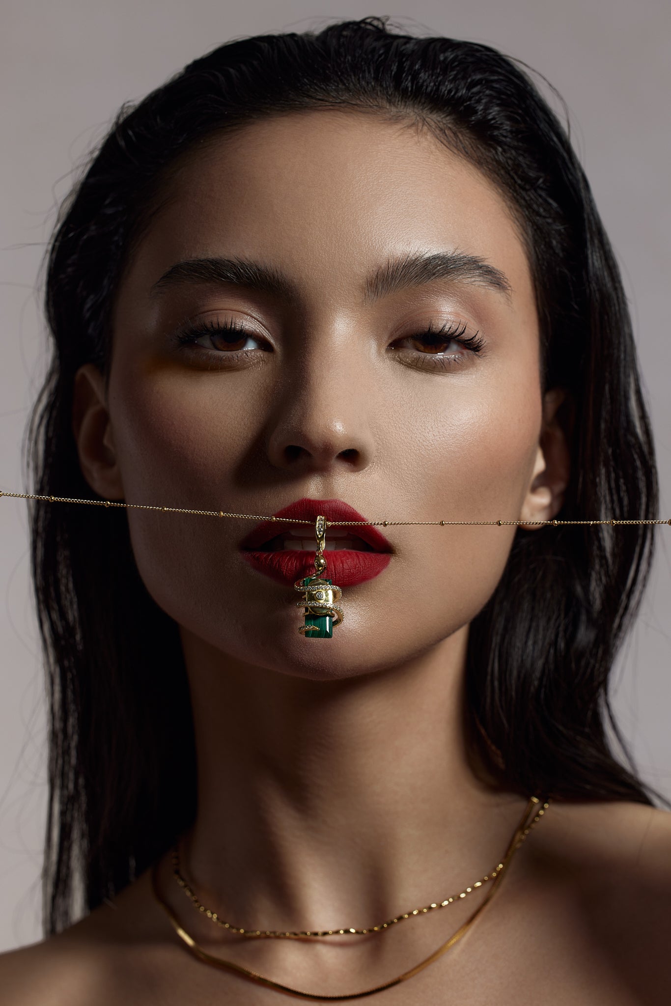 Serpent Charm pendant worn on model with gold chain necklace - FREQNC spirit animal