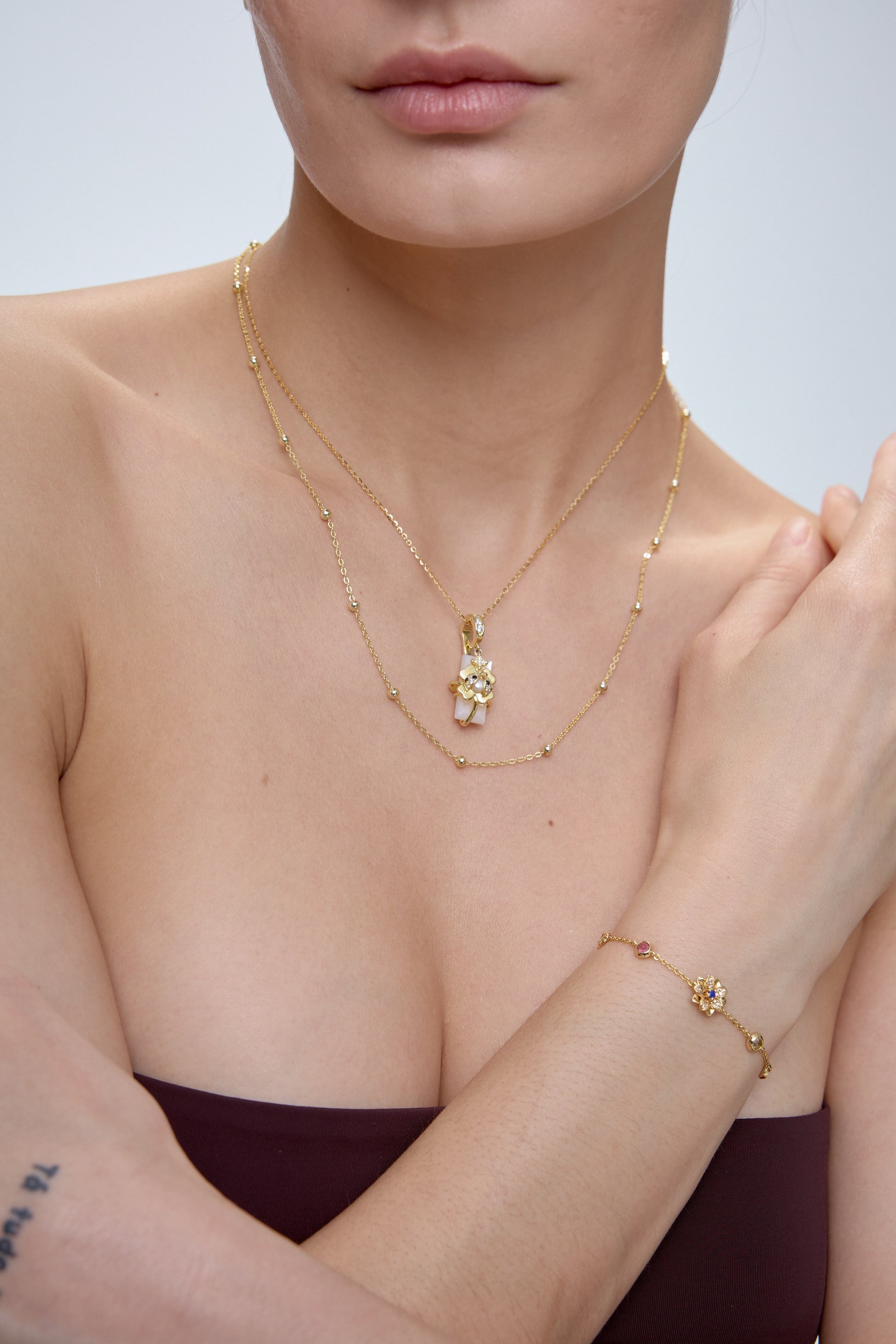 Ladybug Clover Charm pendant worn on model with gold chain - FREQNC spirit animal