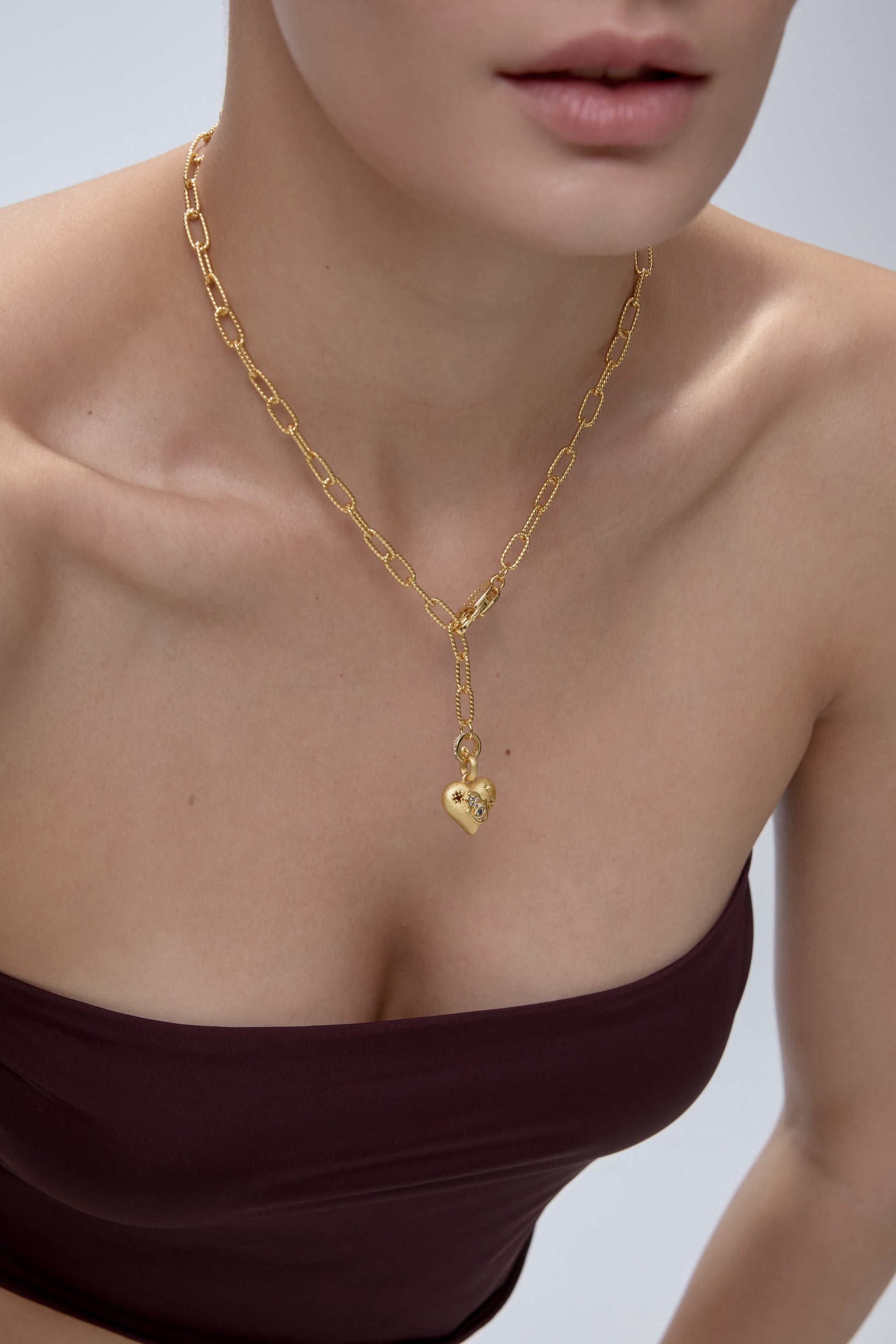 Alchemy of Love Charm worn on model with gold chain - FREQNC atelier