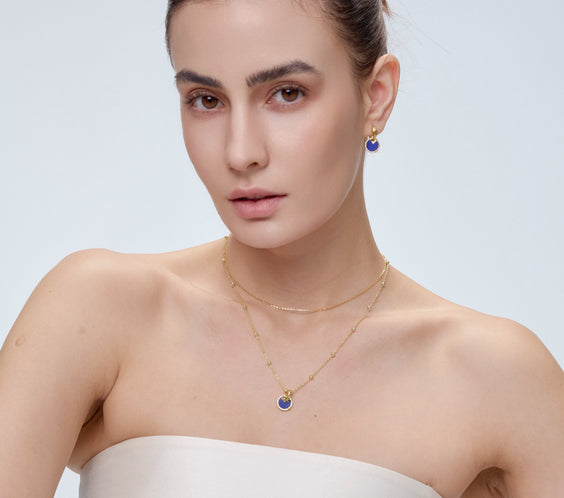 Star Charm worn on model with gold chain necklace - FREQNC