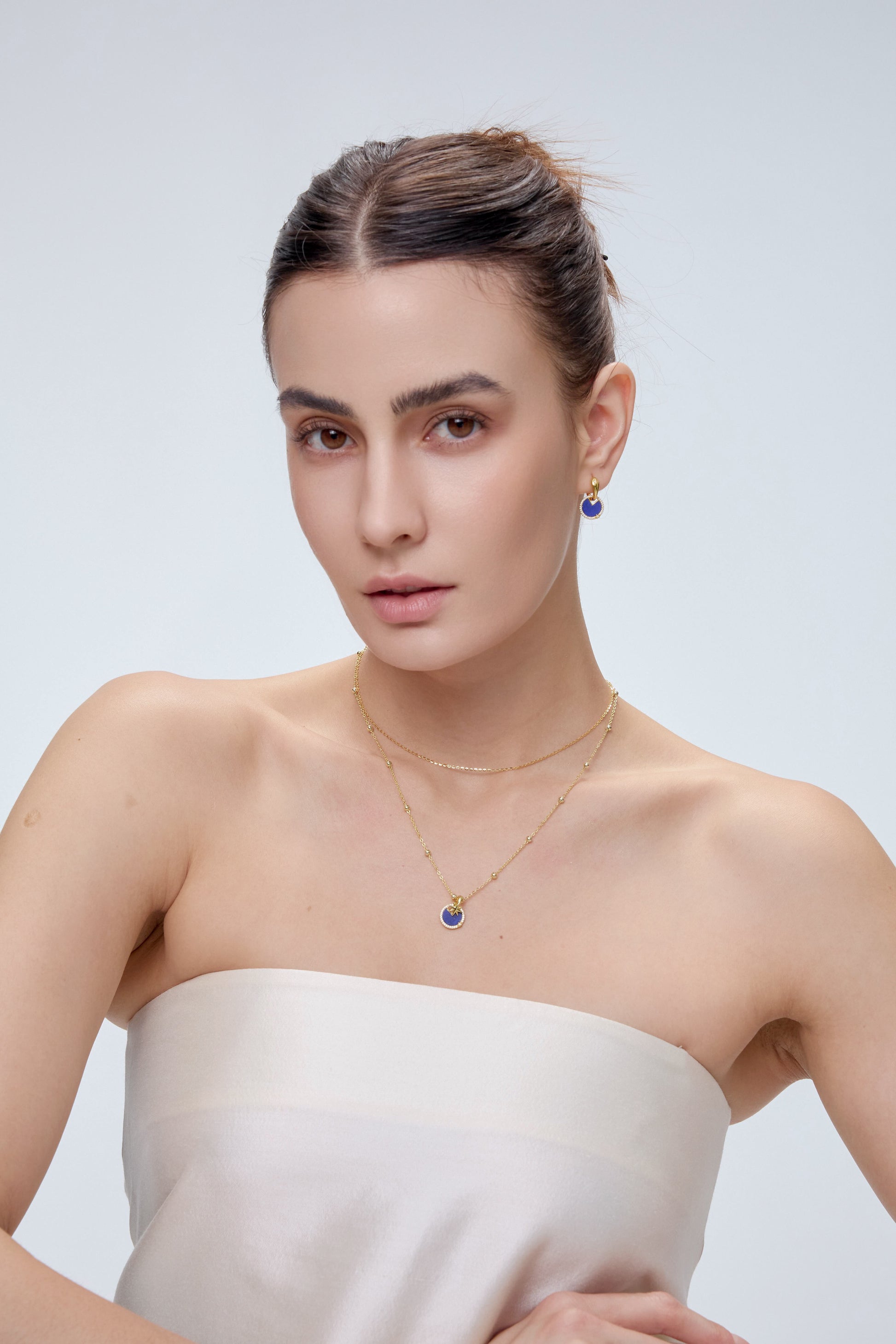 Star Charm worn on model with gold chain necklace - FREQNC