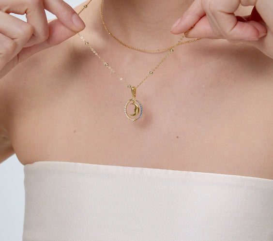 Moon Charm crescent pendant styling close-up - FREQNC atelier
