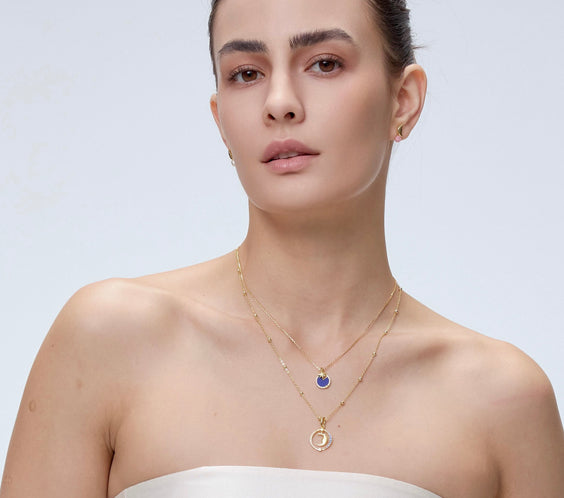 Moon Charm worn on model with gold chain necklace - FREQNC