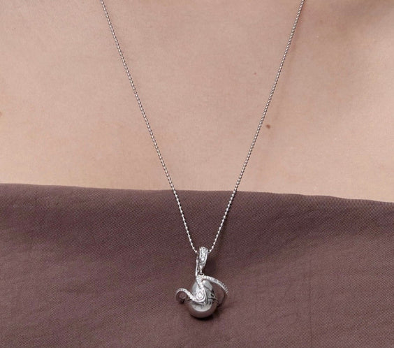 Orphic Egg Charm open view showing zodiac crystal inside - FREQNC atelier