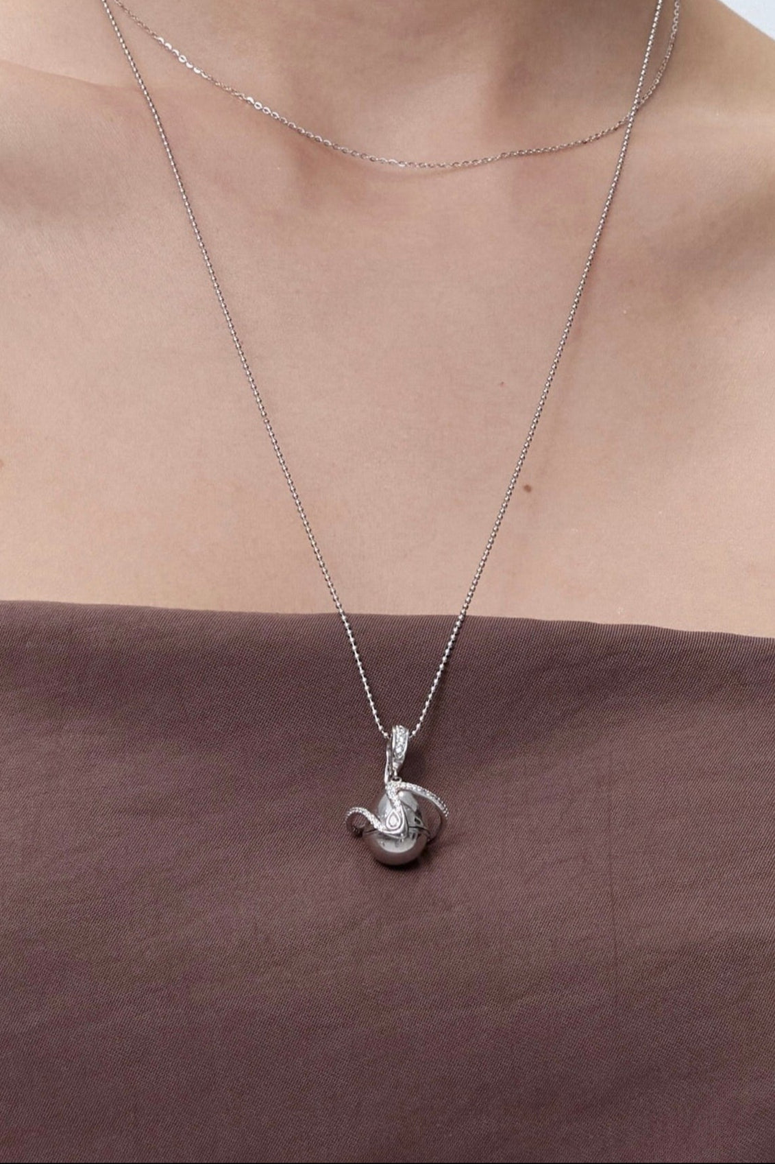 Orphic Egg Charm open view showing zodiac crystal inside - FREQNC atelier