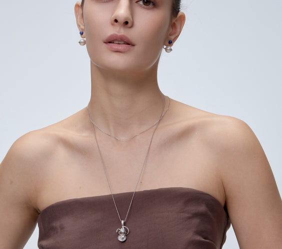 Orphic Egg Charm pendant styling with layered necklace - FREQNC