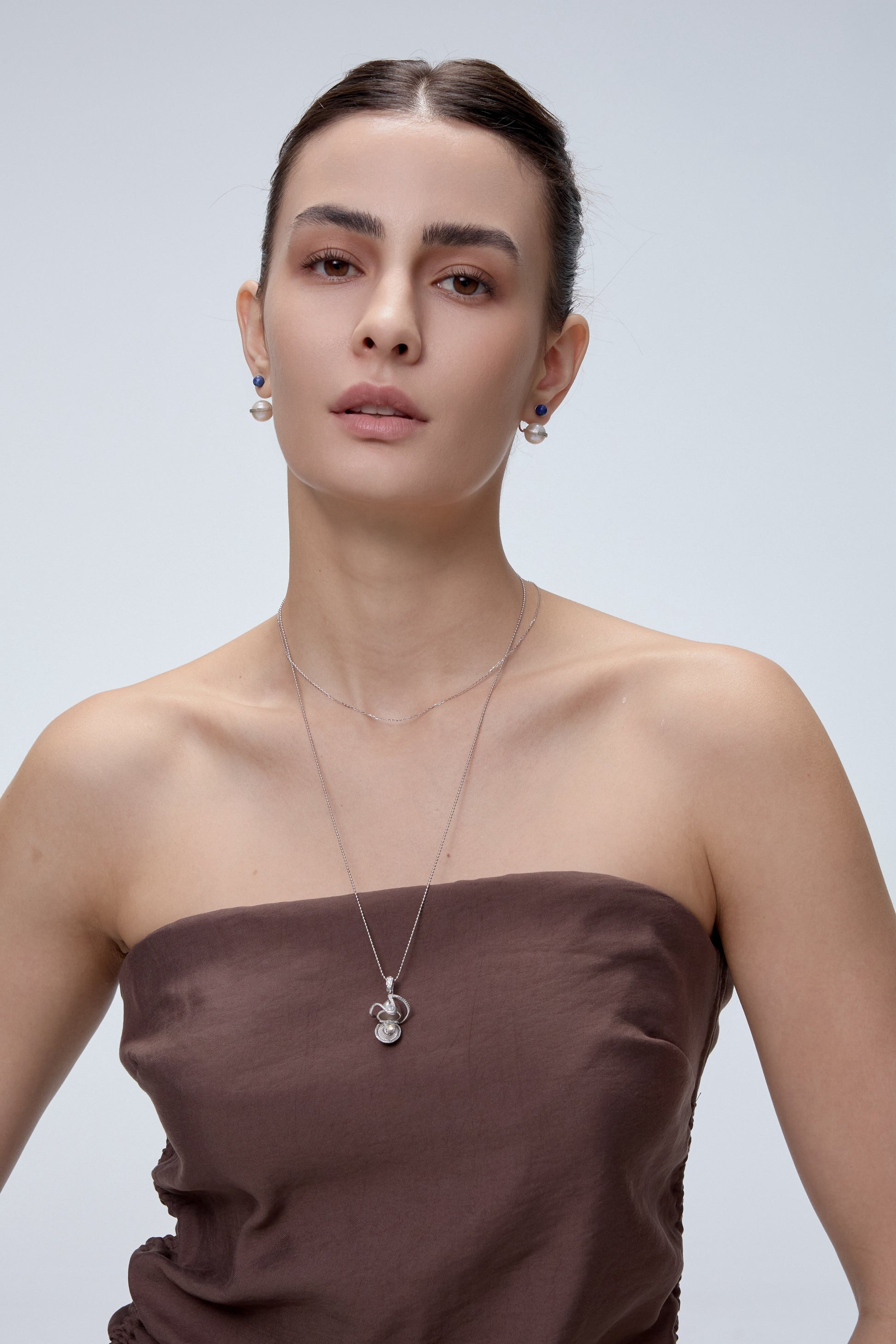Orphic Egg Charm pendant styling with layered necklace - FREQNC