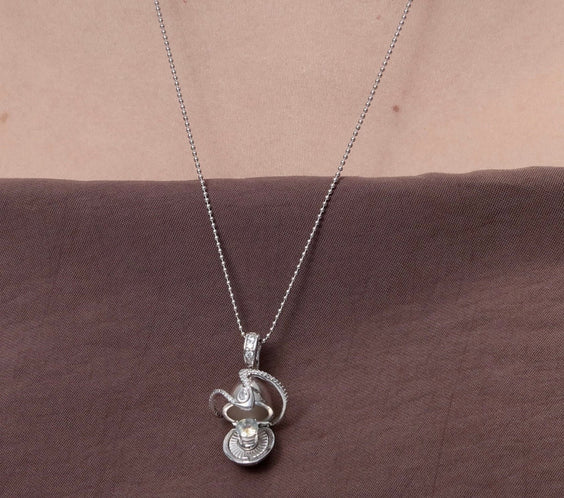 Orphic Egg Charm close-up detail of serpent and egg design - FREQNC atelier
