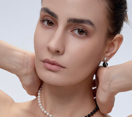 Orphic Egg Earrings asymmetric styling on model - FREQNC atelier