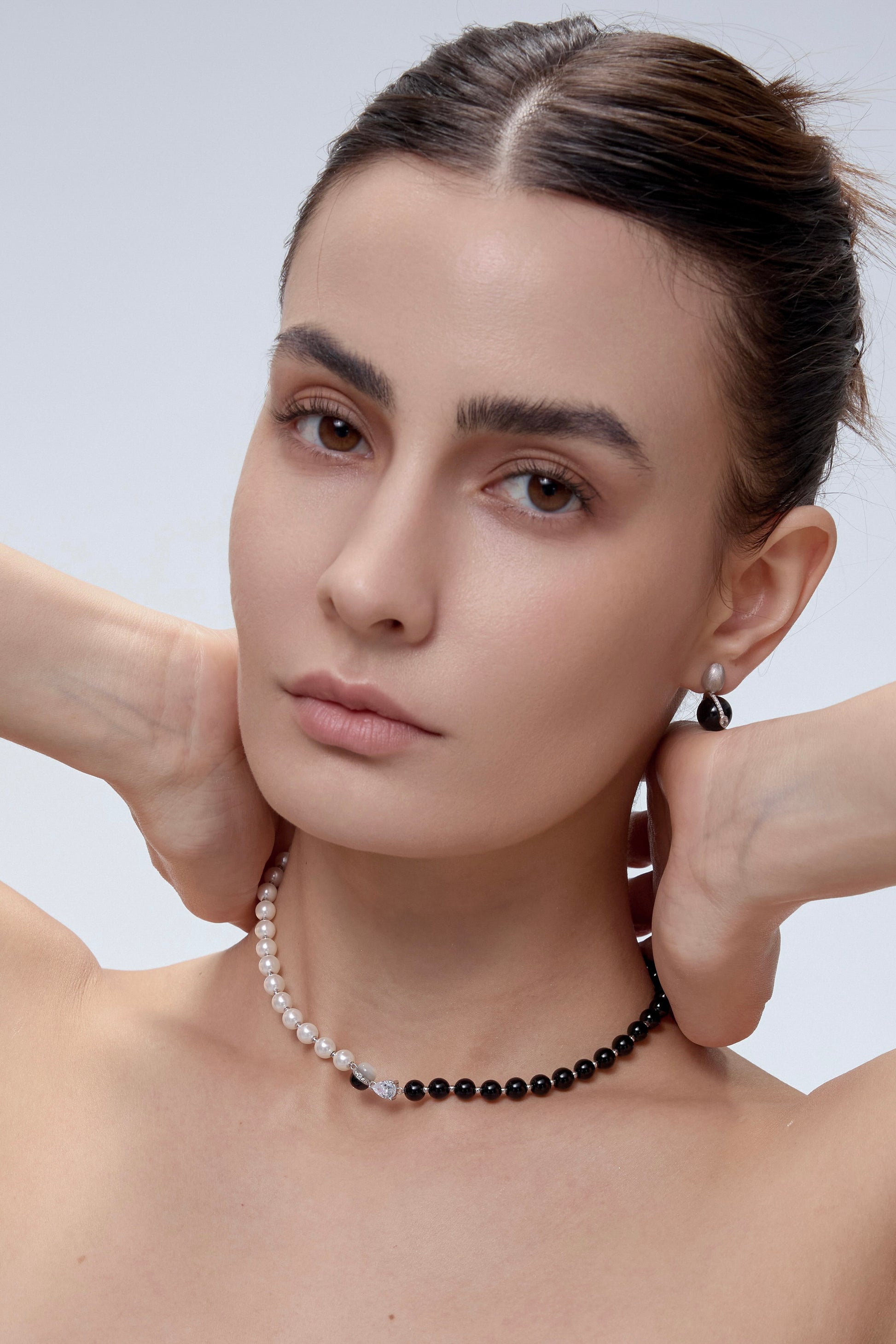 Orphic Egg Earrings asymmetric styling on model - FREQNC atelier