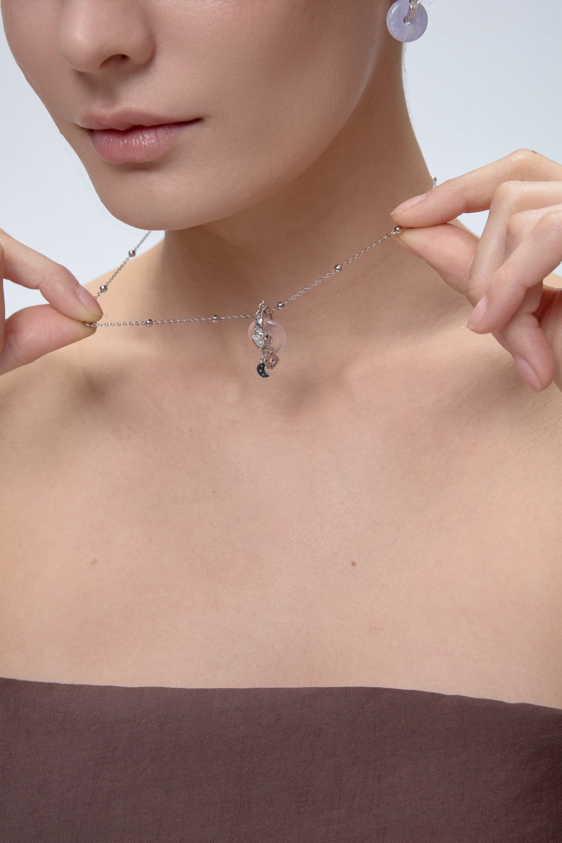Ouroboros Charm with interchangeable donut crystal close-up - FREQNC