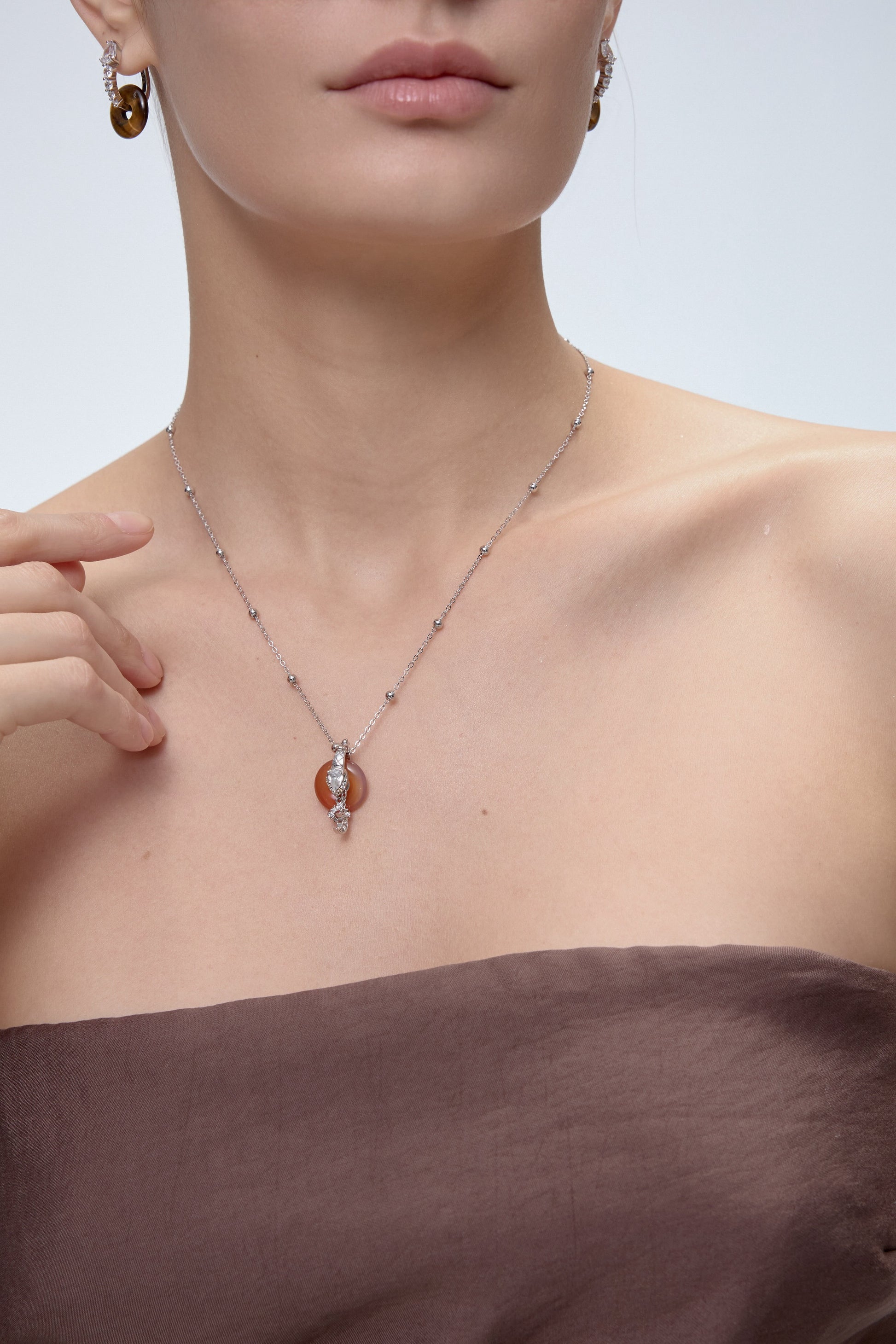 Ouroboros Charm pendant with clear quartz crystal detail - FREQNC