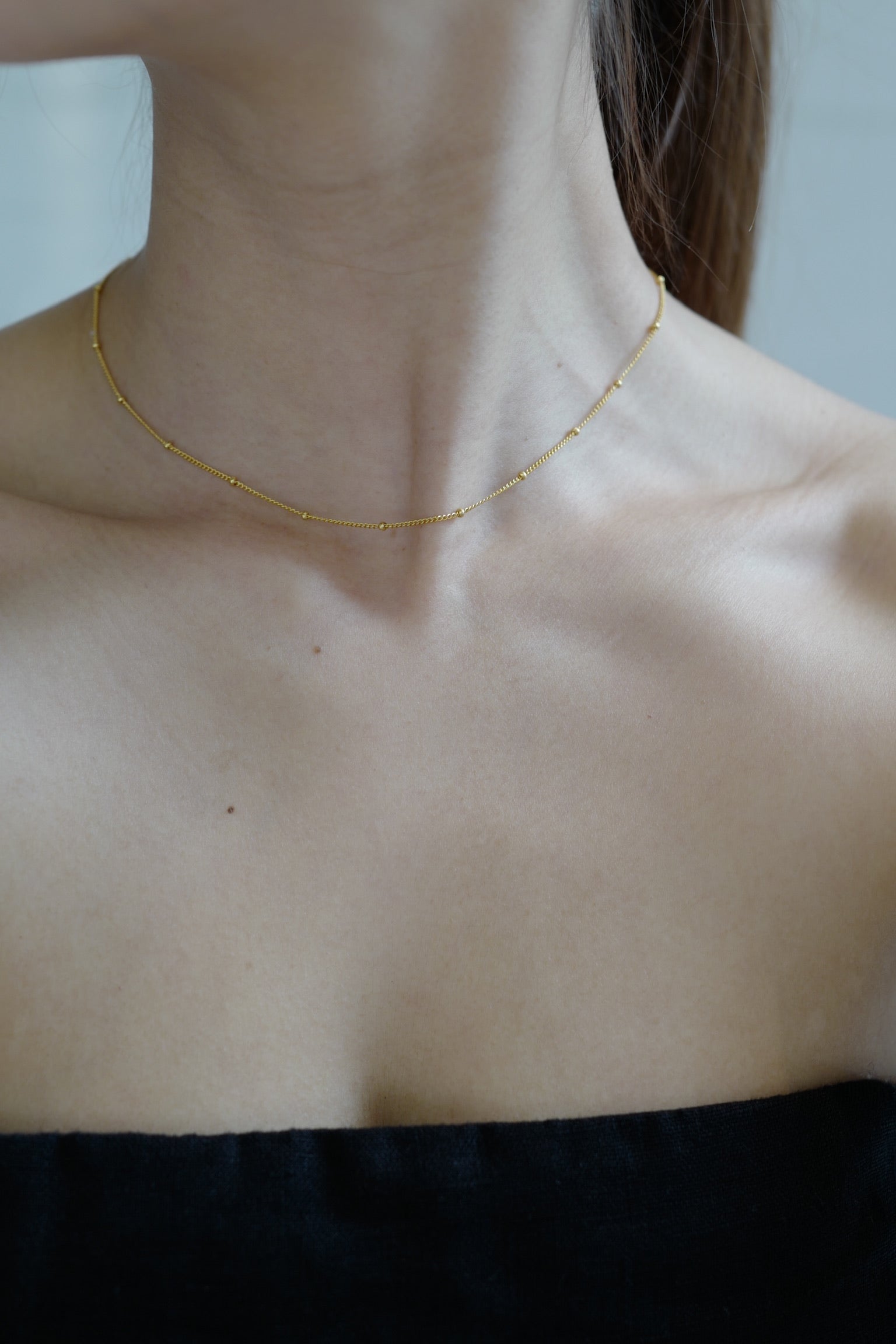 Rhea Gold Dot Necklace product detail close-up - FREQNC