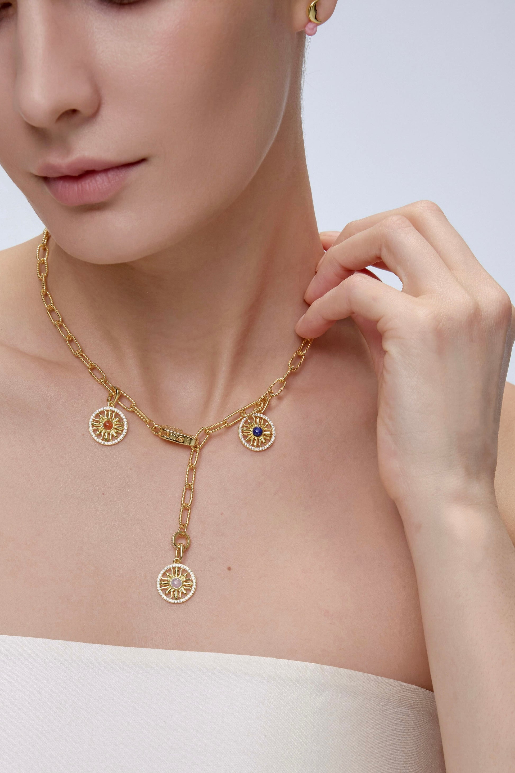 Sun Charm worn on model with layered necklace styling - FREQNC