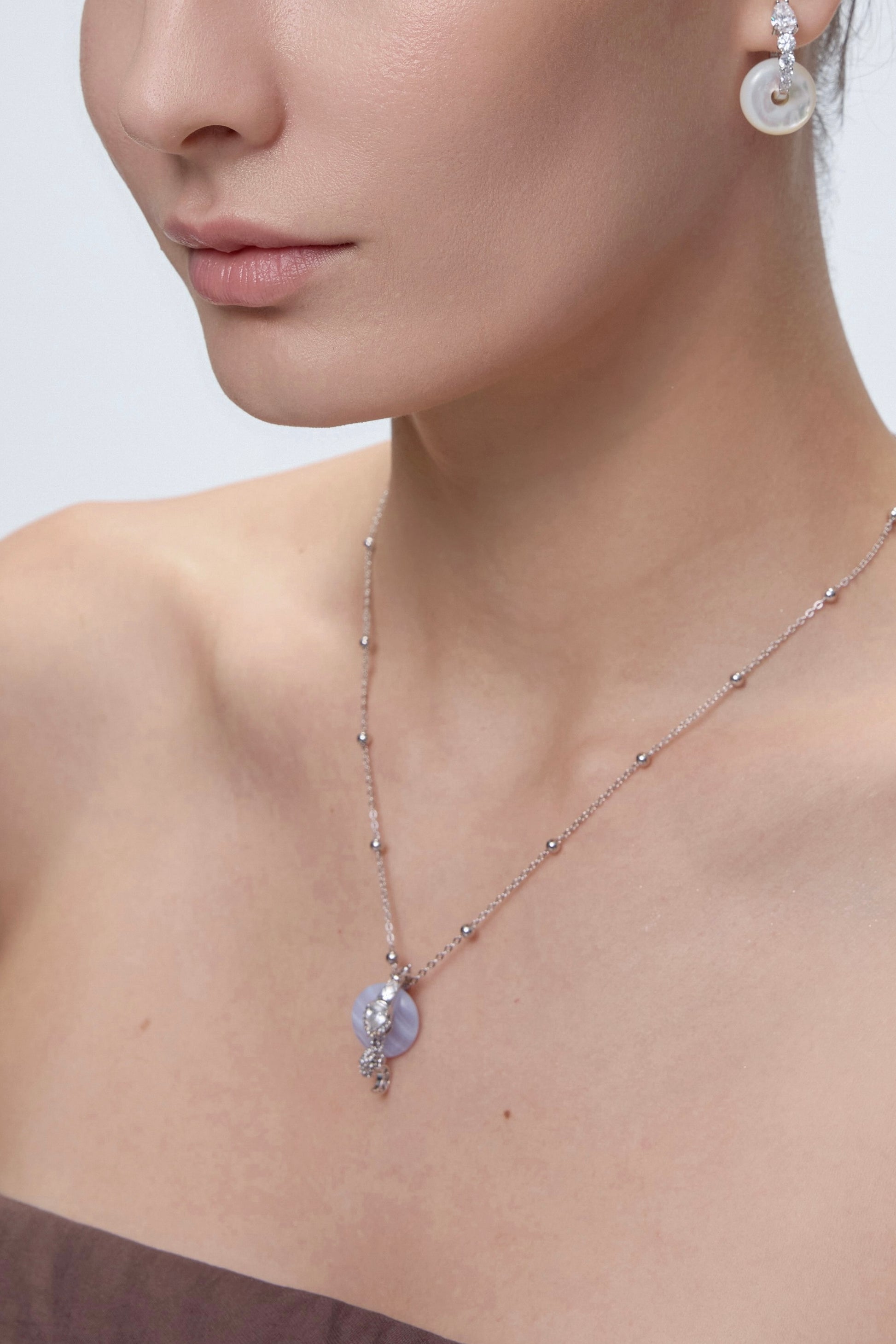 Rhea Beaded Necklace layered on model with pendant - FREQNC