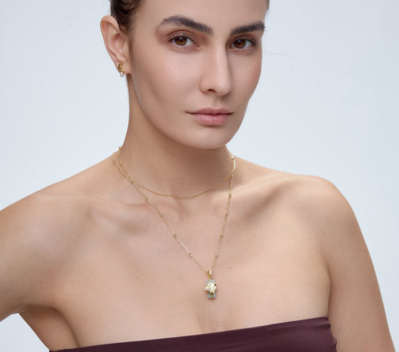 HexaMyst Bee Charm pendant worn on model with gold chain necklace - FREQNC spirit animal