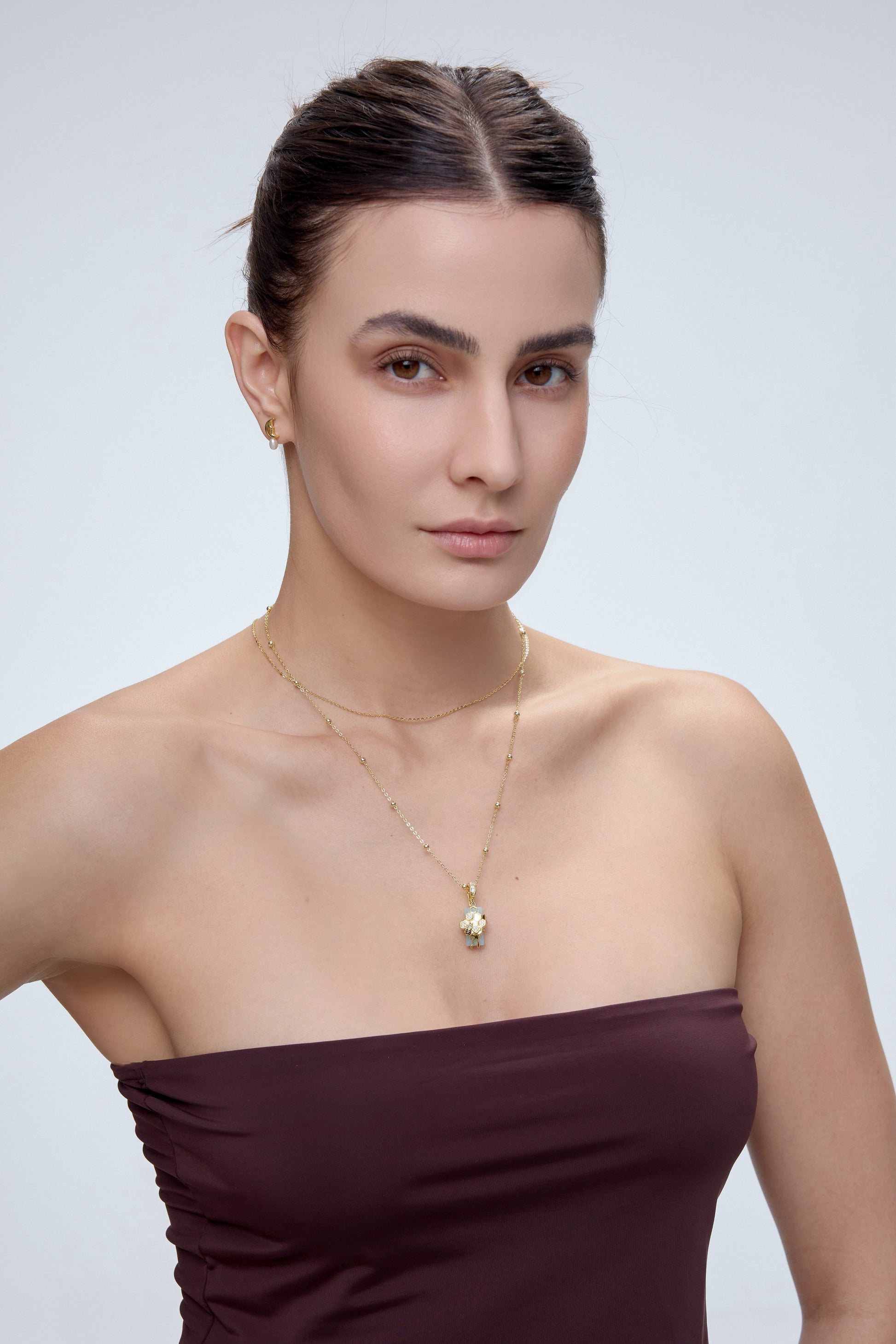 HexaMyst Bee Charm pendant worn on model with gold chain necklace - FREQNC spirit animal
