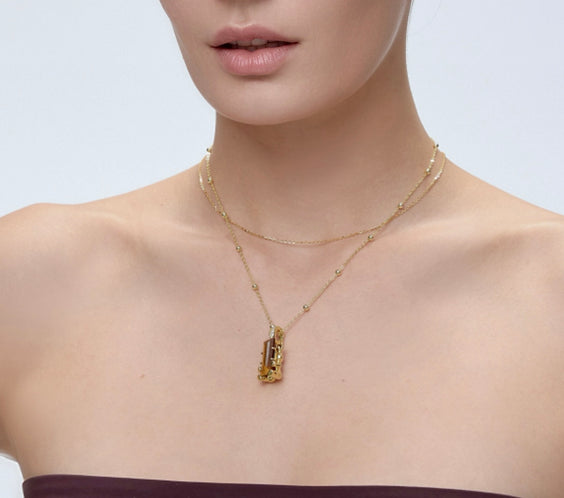 Cuddly Bear Charm with tiger's eye crystal worn on model with gold layered necklace - FREQNC magnetic pendant