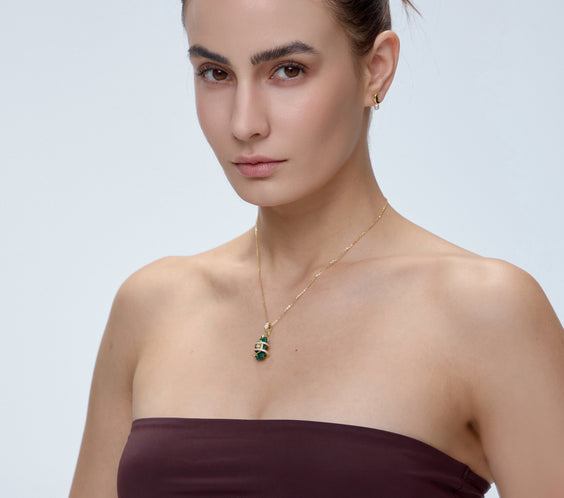 Serpent Charm with malachite crystal pendant worn on model - FREQNC magnetic gemstone jewelry