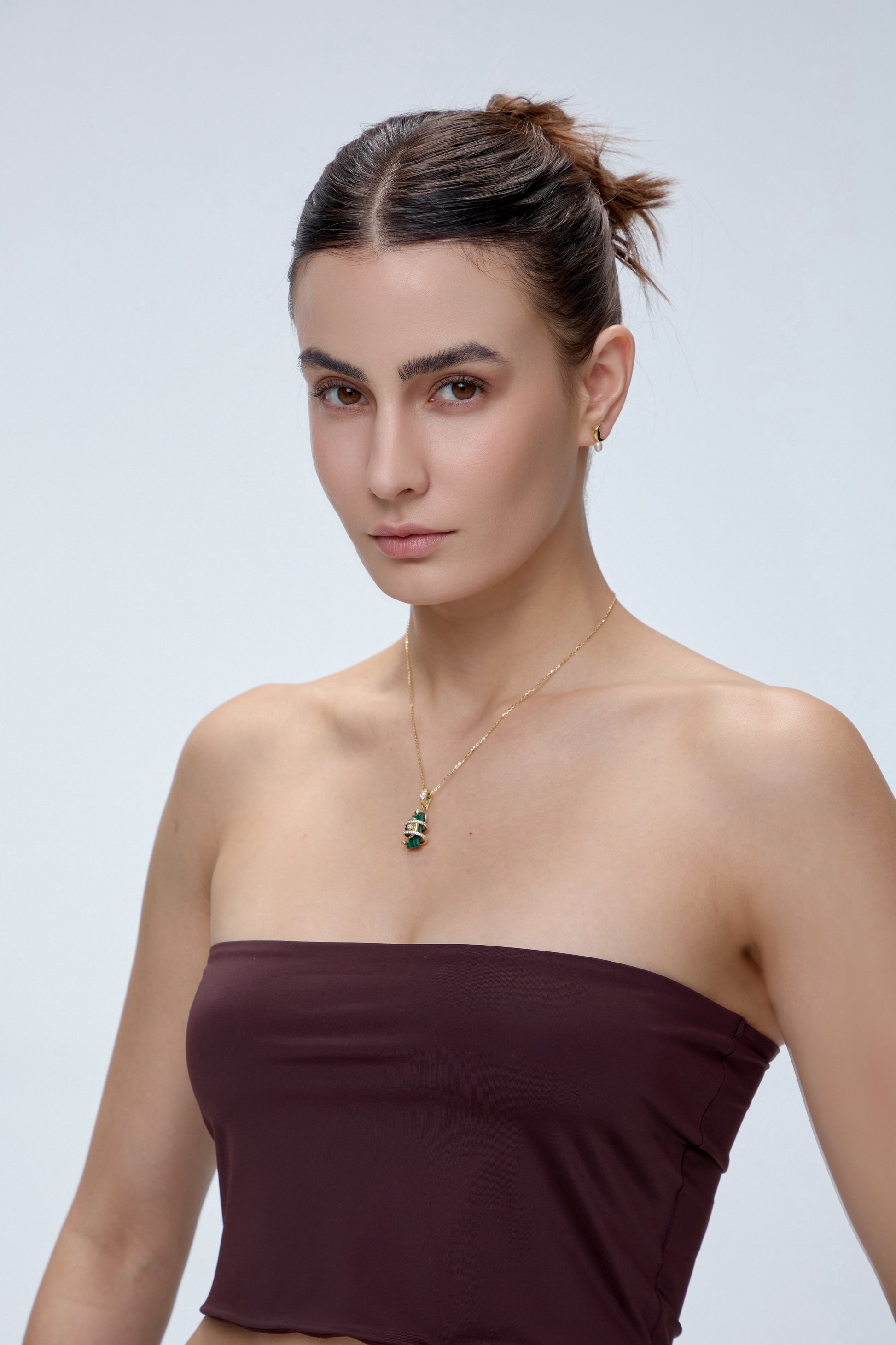 Serpent Charm with malachite crystal pendant worn on model - FREQNC magnetic gemstone jewelry