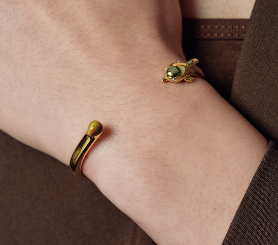 Dolphin Bangle worn on model wrist close-up - FREQNC spirit animal