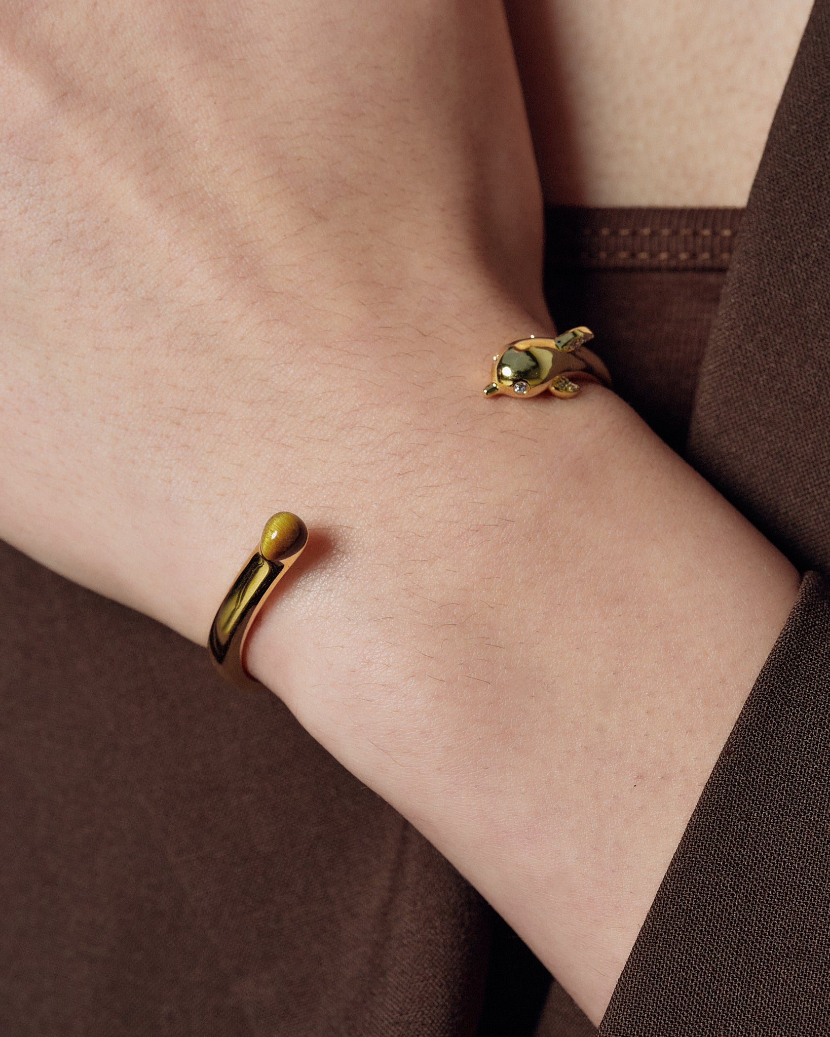 Dolphin Bangle worn on model wrist close-up - FREQNC spirit animal