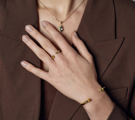 Dolphin Bangle worn on model with layered bracelets - FREQNC