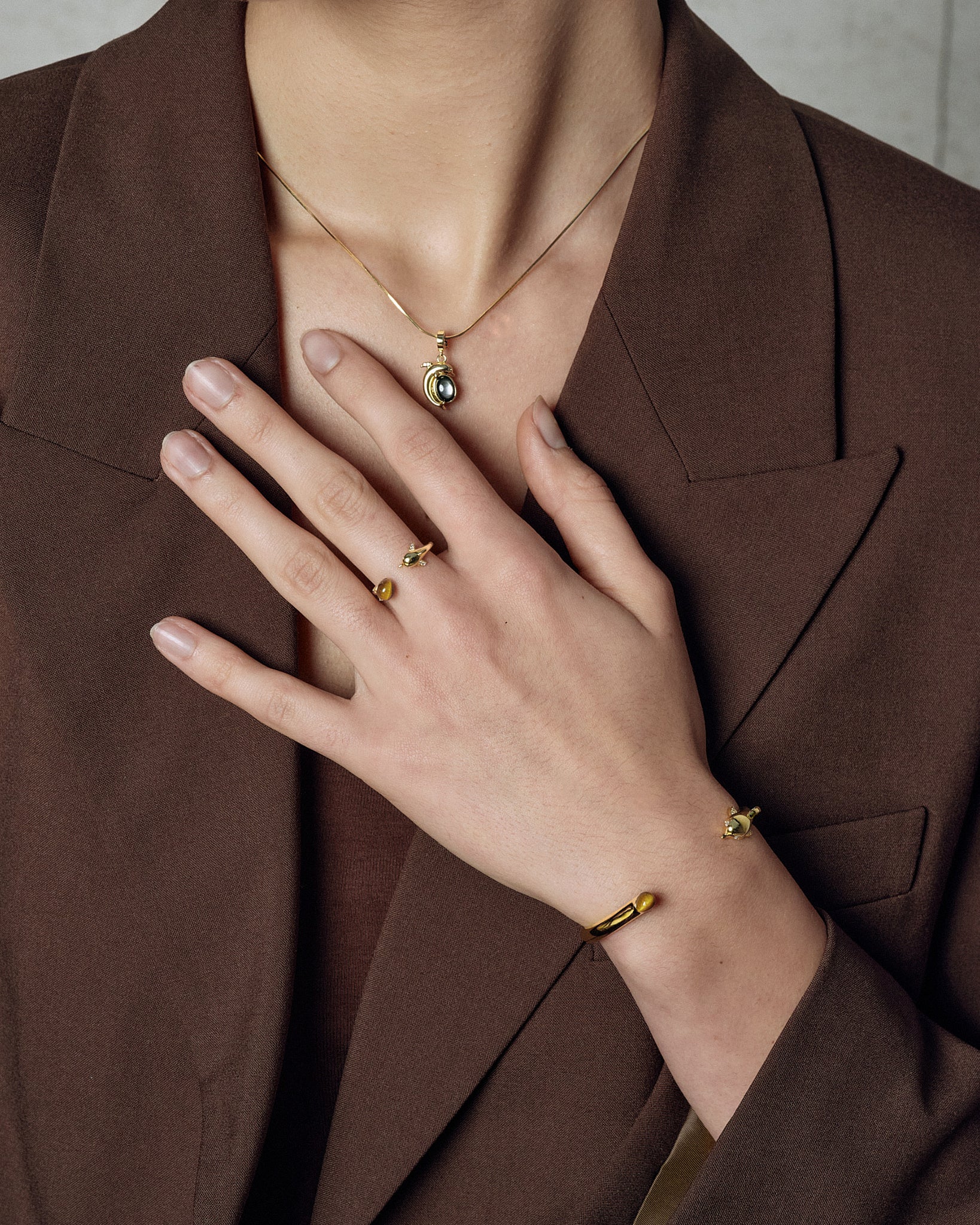 Dolphin Bangle worn on model with layered bracelets - FREQNC