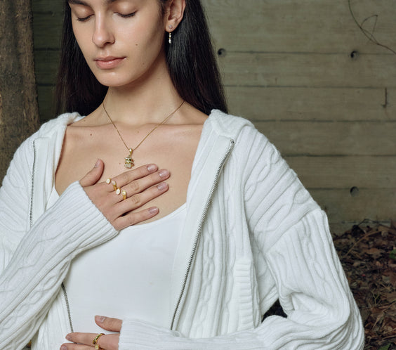 model wearing serpent ring gold while meditation FREQNC atelier