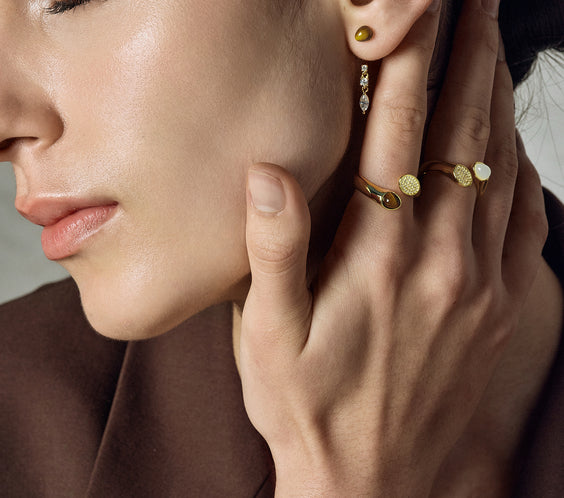 model wearing serpent ring and earrings gold FREQNC atelier